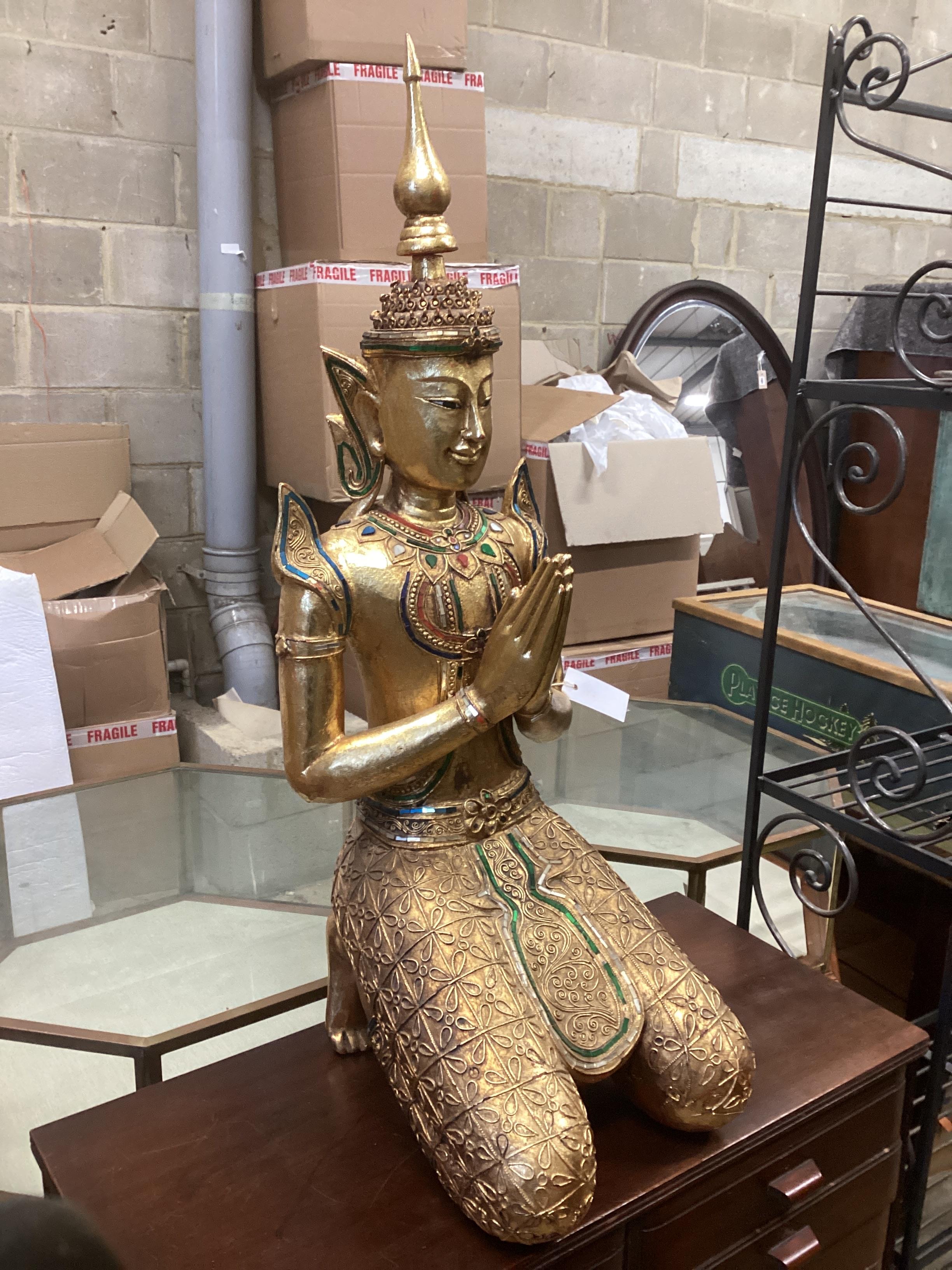 A Thai carved giltwood glass inset kneeling buddha, height. 90cm.